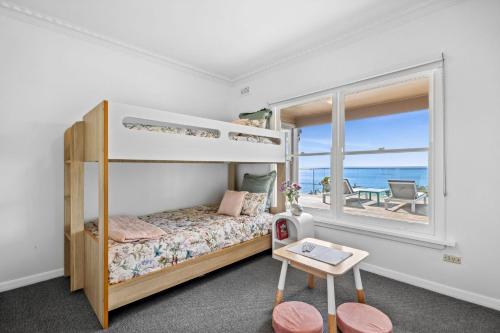 a bedroom with a bunk bed with a view of the ocean at Lorne Beach Views in Lorne