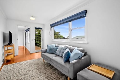 a living room with a couch and a window at Lorne Beach Views in Lorne