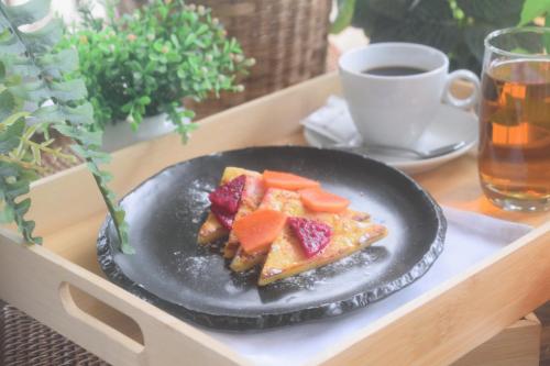 a plate of food with fruit on a tray at The View Serviced Residence 豪景日式酒店公寓 in Phnom Penh