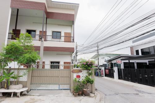 a building with plants on the side of a street at 94Home Donmuang in Bang Khen