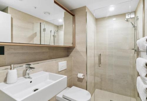 a bathroom with a sink and a shower at Modern Luxury Condo Shotover Views in Queenstown