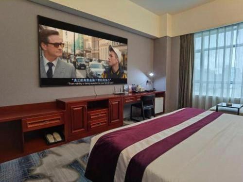 a hotel room with a bed and a flat screen tv at Fuzhou Xin Zi Yang Hotel in Fuzhou