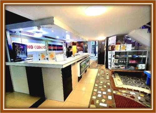 a store with a counter and a woman in a store at OYO 1141 Healing Condo Hotel in Pampang