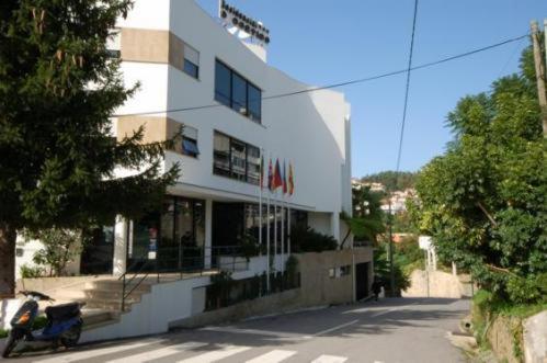 a building with a motorcycle parked in front of it at Hotel O Cortiço in Sever do Vouga
