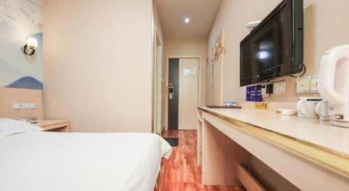 a hospital room with a bed and a television at Super 8 Hotel Jinan Railway Station Square in Jinan