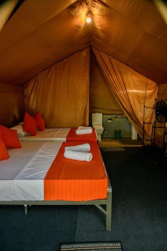a bedroom with a bed in a tent at Mango Safari Camping Udawalawe in Udawalawe