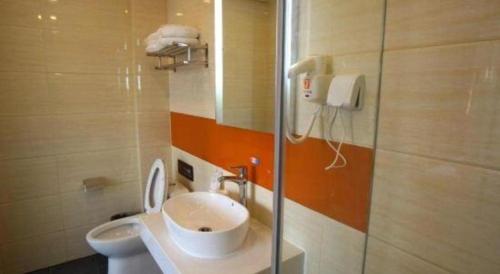 a bathroom with a toilet and a sink and a phone at 7 Days Premium Beijing Dabaotai Metro Station Luhua Road in Beijing