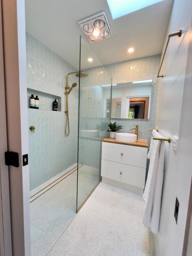 a bathroom with a shower and a sink at Spindrift Falmouth, adventurers coastal haven in Falmouth