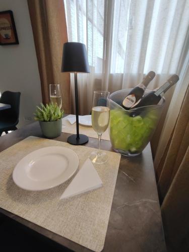 a table with a plate and a glass of wine at Quintadecima Rooms in Palermo