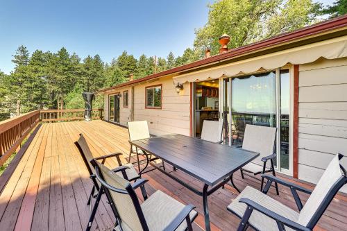 a deck with a table and chairs on a house at Stunning Deck Views Cozy Running Springs Cabin in Running Springs