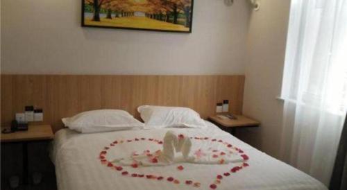 a bed with a heart made out of roses at PAI Hotels Shijiazhuang Railway Station West Square in Shijiazhuang