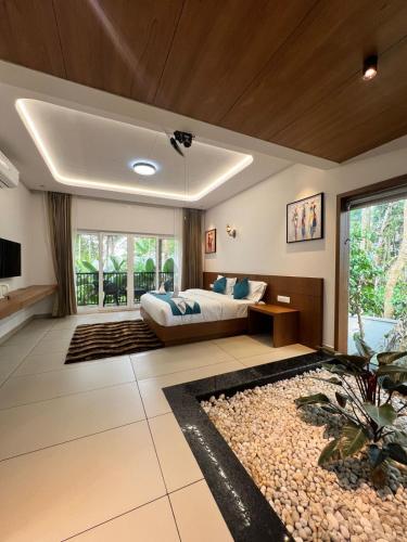 a bedroom with a bed and a large window at Snow white resort wayanad in Wayanad