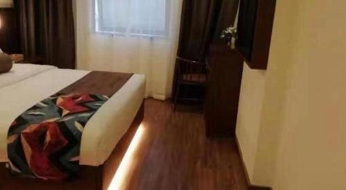a hotel room with a bed and a window at James Joyce Coffetel Guilin Railway Station Xiangbi Mountain Liangjiang Sihu Wharf in Guilin