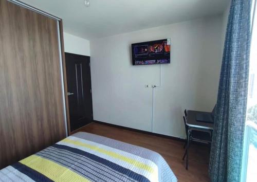 a bedroom with a bed and a sliding glass door at inti apart center in Cusco