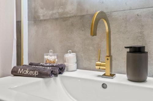 a sink with a faucet and towels on it at Stylish 1BR 1,5BA Old City Condo Near Liberty Bell in Philadelphia