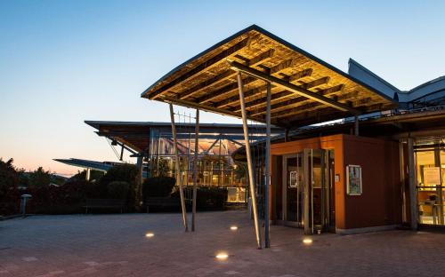 a building with awning in front of a building at Ferienhaus Holunderweg an der Theme Obernsees mit Sauna in Truppach