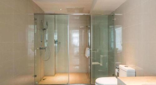 a bathroom with a glass shower with a toilet at City Comfort Inn Lhasa Potala Palace Scenic View in Lhasa