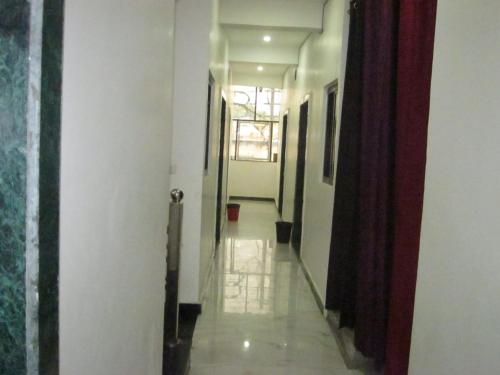 a hallway with a long corridor with doors and a room at Shri prabhu dham- Near Prem Mandir in Vrindāvan
