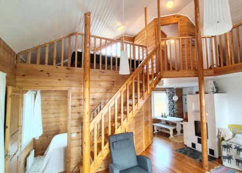 a large room with a spiral staircase in a house at Villa Dyyni - Oulujärvi Manamansalo in Vaala