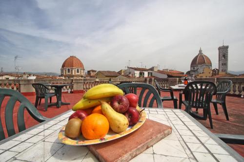 a plate of fruit on a table on a balcony at Soggiorno La Cupola Guesthouse in Florence
