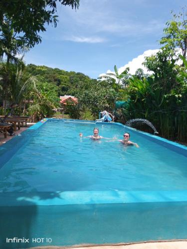 two people in the swimming pool at a resort at Lanta Dareen Garden Home in Ko Lanta