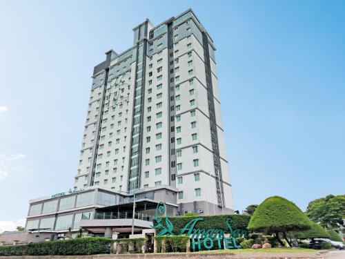 a large white building with a sign in front of it at Amansari Hotel Nusajaya in Nusajaya
