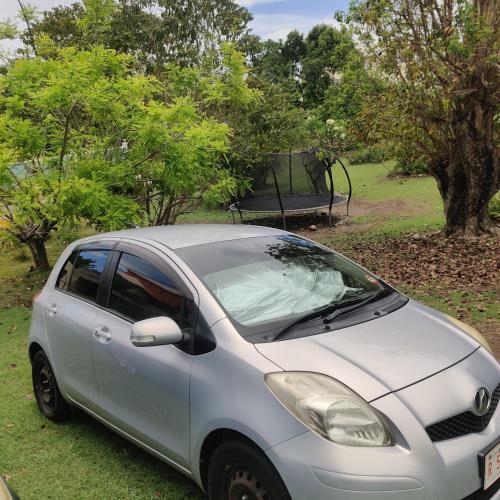 a small silver car parked in a field at LaBelleVue Antigua Oceanview Suites and OnSite Car Rentals in Crosbies