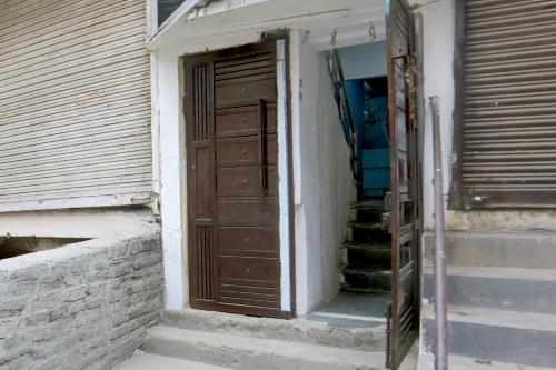 an open door of a building with stairs next to it at Super Hotel O Dream Palace in Delhi