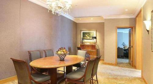 a dining room with a table and chairs at Regency Hotel in Shantou