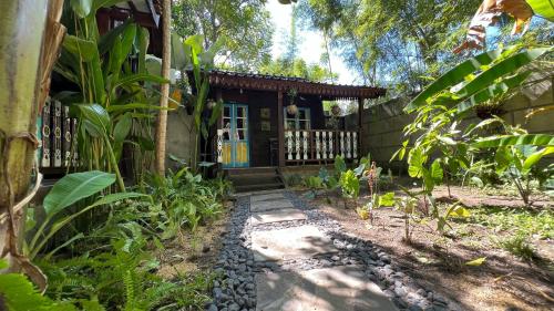 a garden with a house with a fence at Tahlia's Villa in Sorongjukung