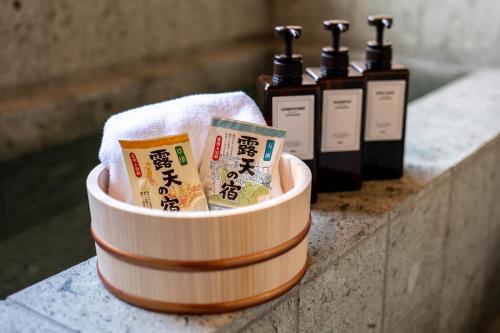 a container filled with bottles of soap on a counter at 古民家一棟貸別荘 しずく亭 -Kominka SHIZUKU tei- in Mobara