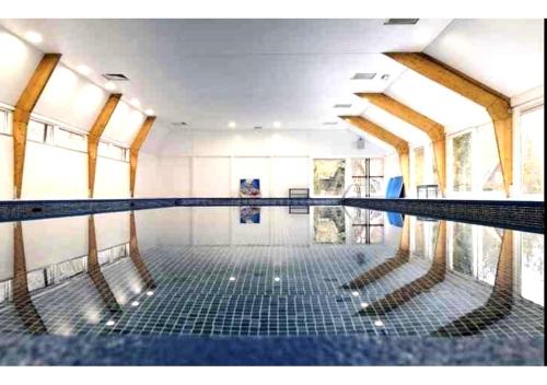 a swimming pool with empty seats in the middle at Chalet Séquoia 138 Nature, piscine et chien bienvenu à Durbuy in Durbuy