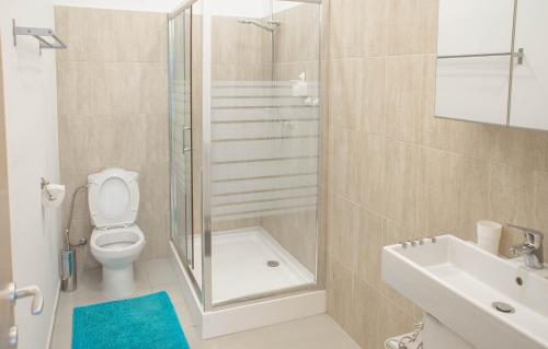 a bathroom with a shower and a toilet and a sink at Old City by CityLife Suites in Bucharest