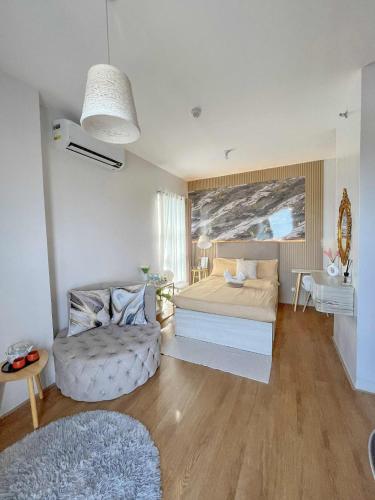 a living room with a bed and a couch at Mesatierra Garden Residences in Davao City