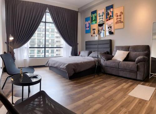a living room with a bed and a couch at Molek Regency Johor Bahru By JC Home in Johor Bahru