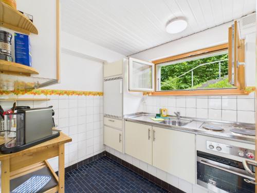 a small kitchen with a sink and a window at Guardian Gate Lodge in Iseltwald