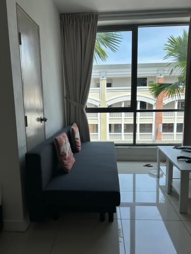 a living room with a couch and a large window at BS Homestay5 - 2R2B Apartment with a Balcony in Miri