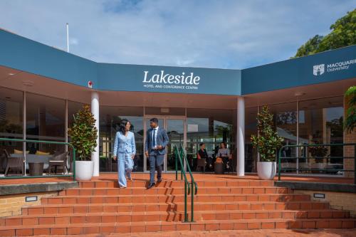 a man and woman walking out of a building at Lakeside Hotel and Conference Centre in Sydney