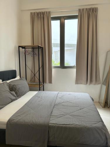 a bedroom with a large bed and a window at BS Homestay5 - 2R2B Apartment with a Balcony in Miri