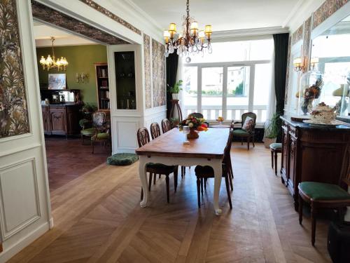 a dining room with a table and chairs at La Maison au toit vert in Espalion