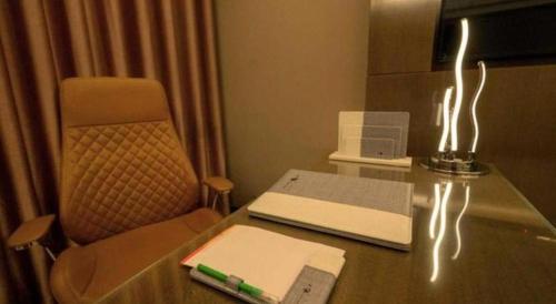 a desk with a laptop and a book on it at Hotel Castle Salam in Khulna