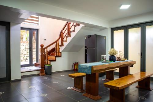 a living room with a table and a staircase at Phong Nha Farmstay in Phong Nha