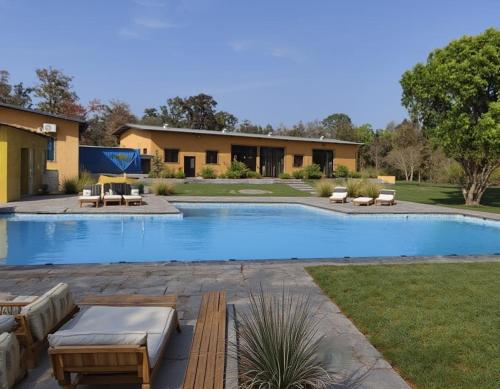 a swimming pool in a yard with a house at Somona Grandeur in Mandlā