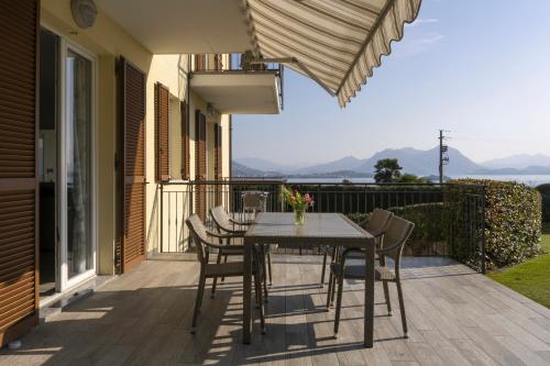 a patio with a table and chairs on a deck at Agrifoglio in Baveno