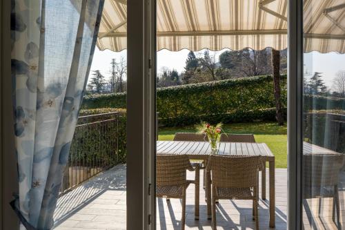 a table and chairs on a patio with a view at Agrifoglio in Baveno