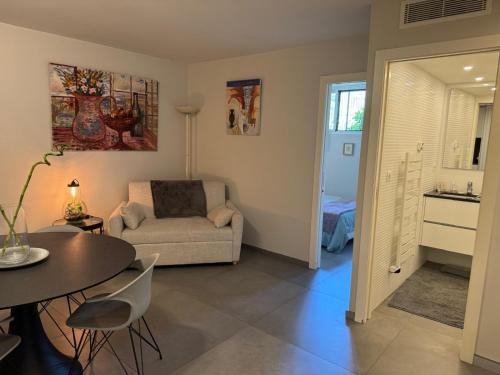 a living room with a couch and a table at Cannes, Mougins, Sophia-Antipolis, Grasse, Nice, Monaco, Saint-Tropez in Mougins