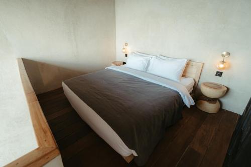 a bedroom with a large bed with white pillows at The Iggy Hotel Seseh Loft 7 Sauna Ice Bath in Cemagi