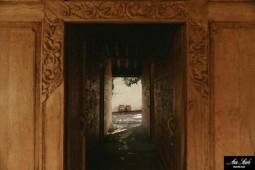 an entrance to a hallway in an old building at The Iggy Hotel Seseh Loft 7 Sauna Ice Bath in Cemagi
