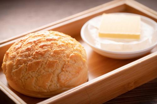 a tray with a loaf of bread and a bowl of butter at Chongqing Marriott Hotel in Chongqing