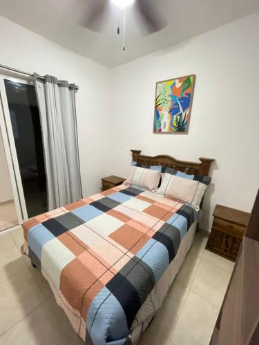 a bedroom with a bed with a colorful blanket at Casa Chuy pueblo mágico in Xochitepec
